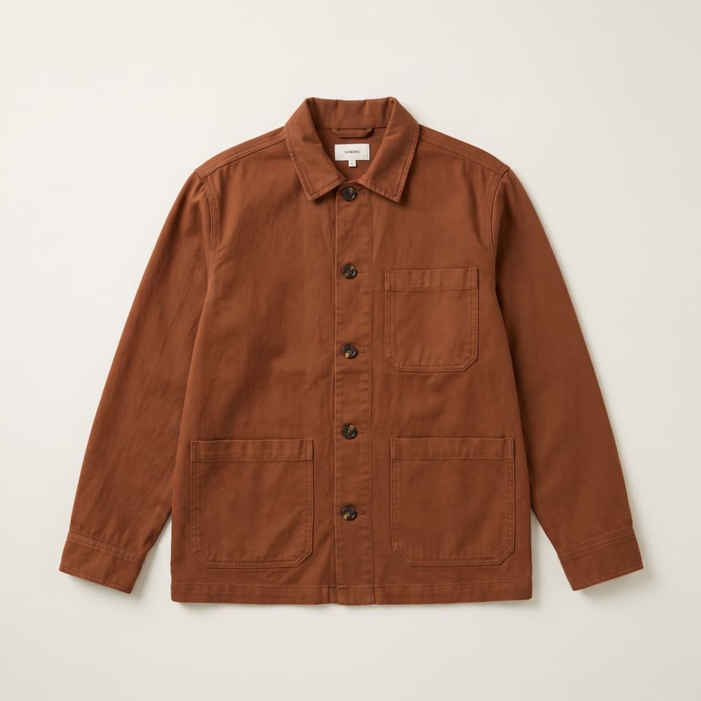 A rust-coloured chore jacket photographed flat